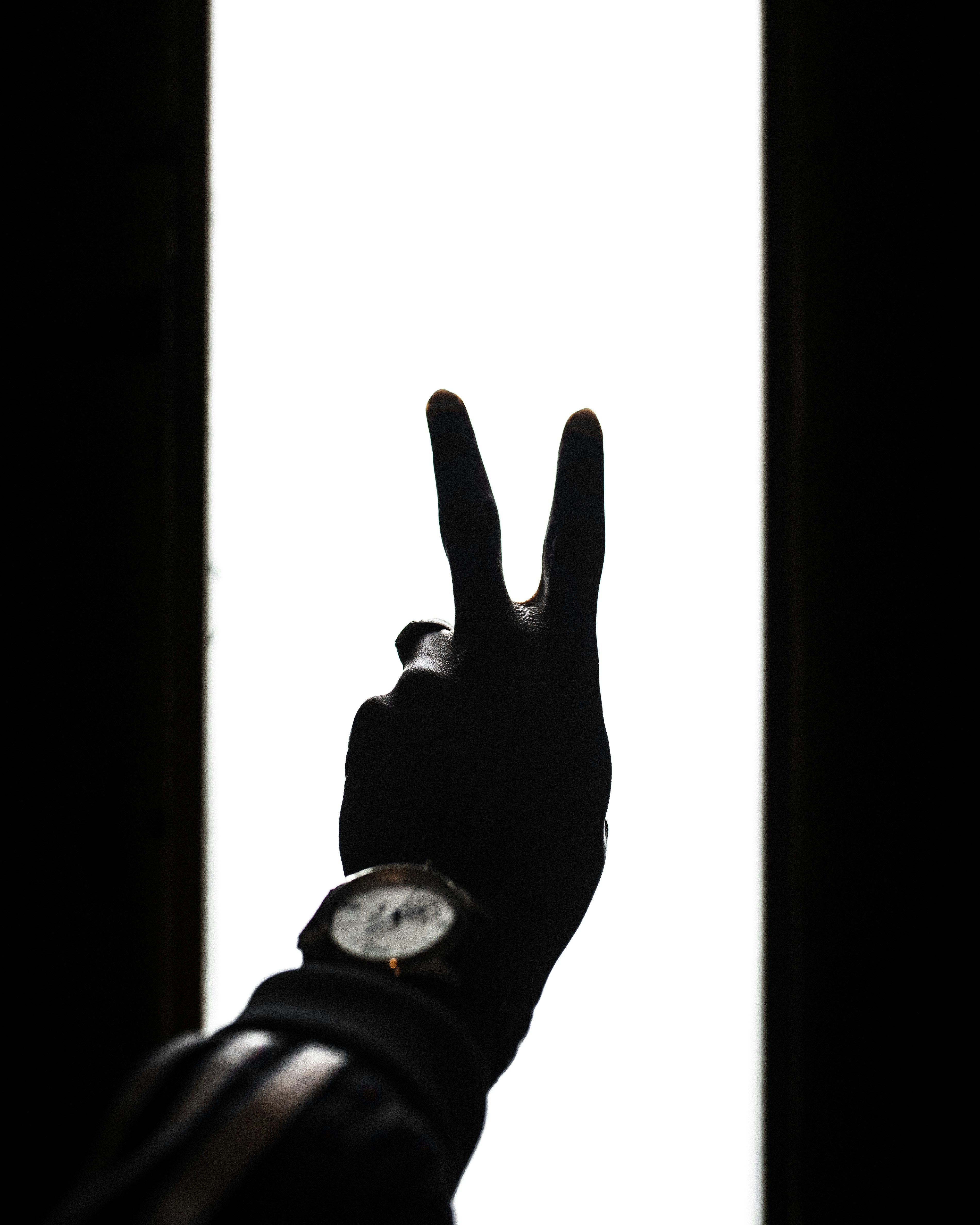 黒い革紐の腕時計を身に着けている人