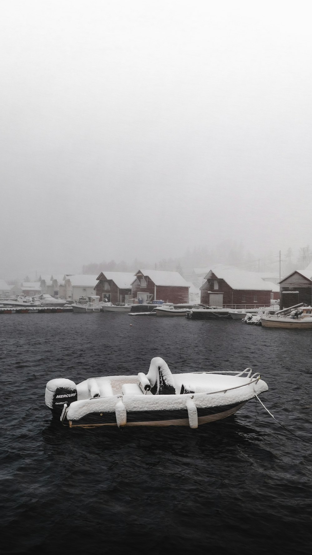 white and black boat on water near city buildings during daytime