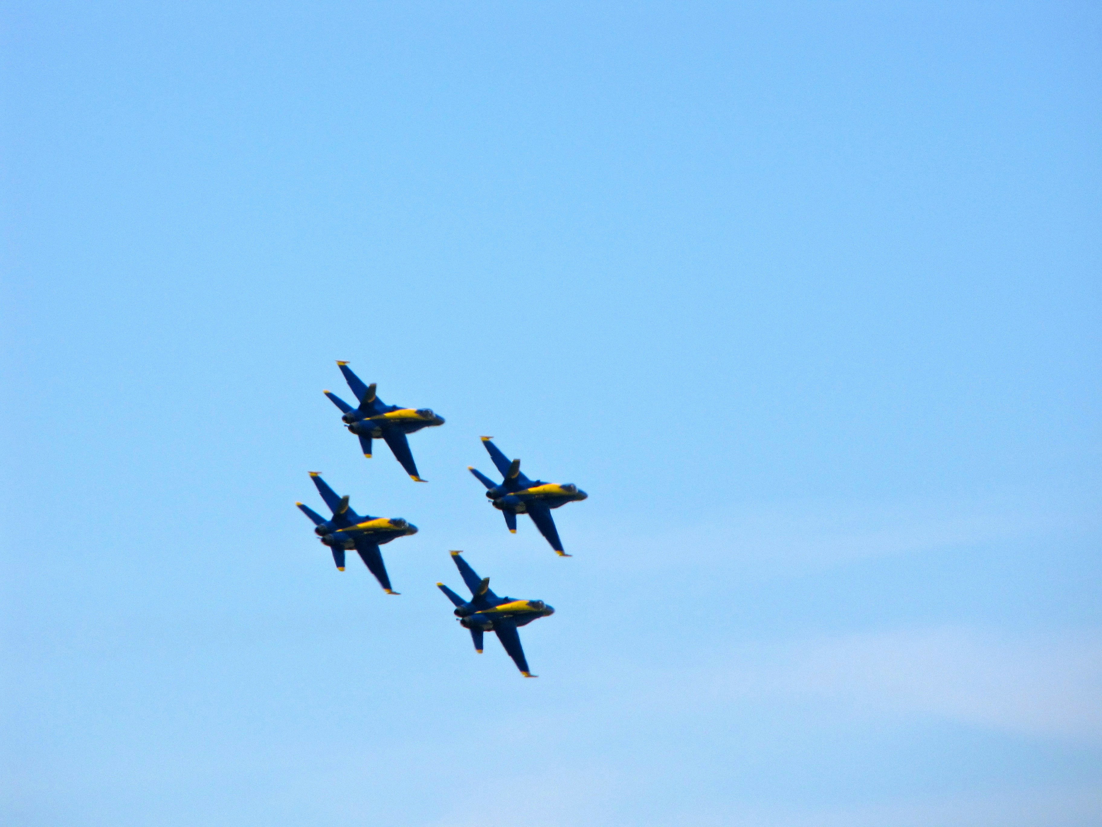 four fighter planes in mid air during daytime