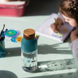 blue and white plastic bottle on white table