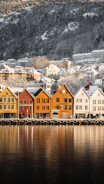 brown and white houses beside body of water during daytime