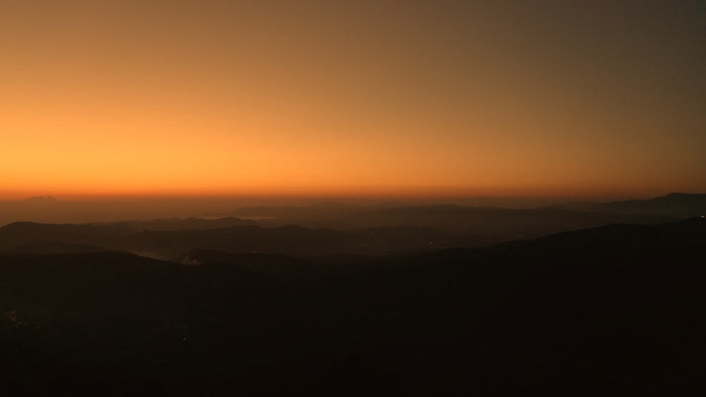 silhouette of mountain during sunset