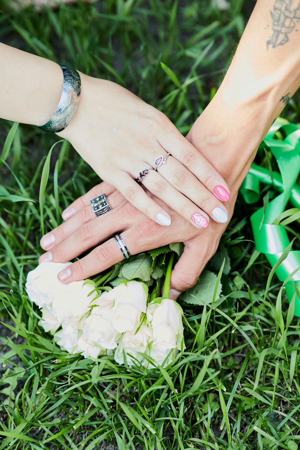 person wearing silver ring holding white flower bouquet