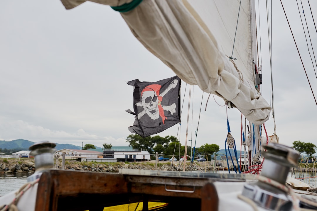 white sail boat on body of water during daytime