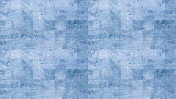 A pattern of blue square tiles arranged in a grid, each tile exhibiting variations in shading and texture, reminiscent of marble.