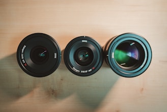 black camera lens on brown wooden table