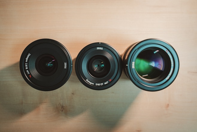 black camera lens on brown wooden table
