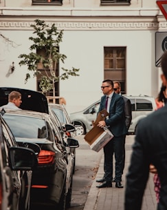 man in black suit standing beside man in blue suit