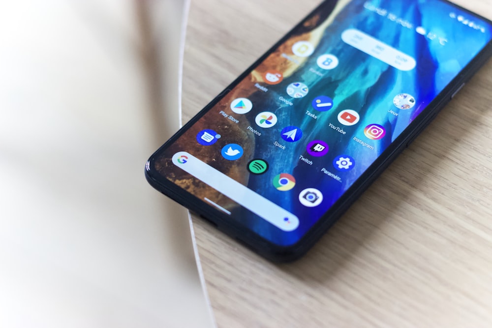 black android smartphone on brown wooden table