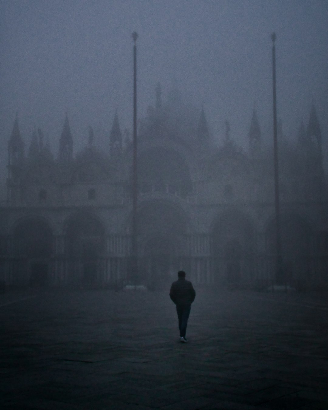 silhouette of person standing in front of building