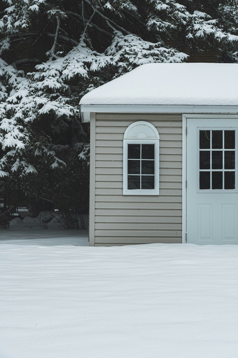 white wooden house covered with snow