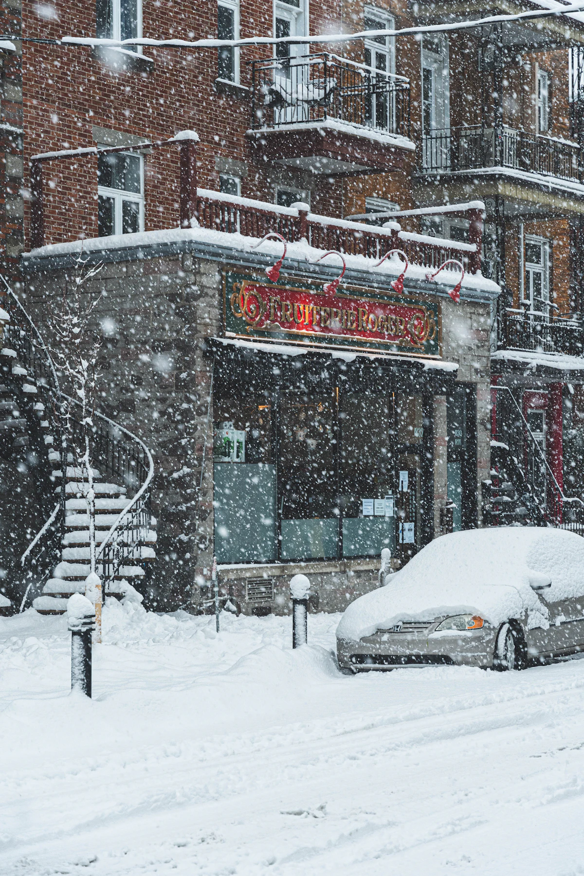 Snowy street next to a brick building in Montreal