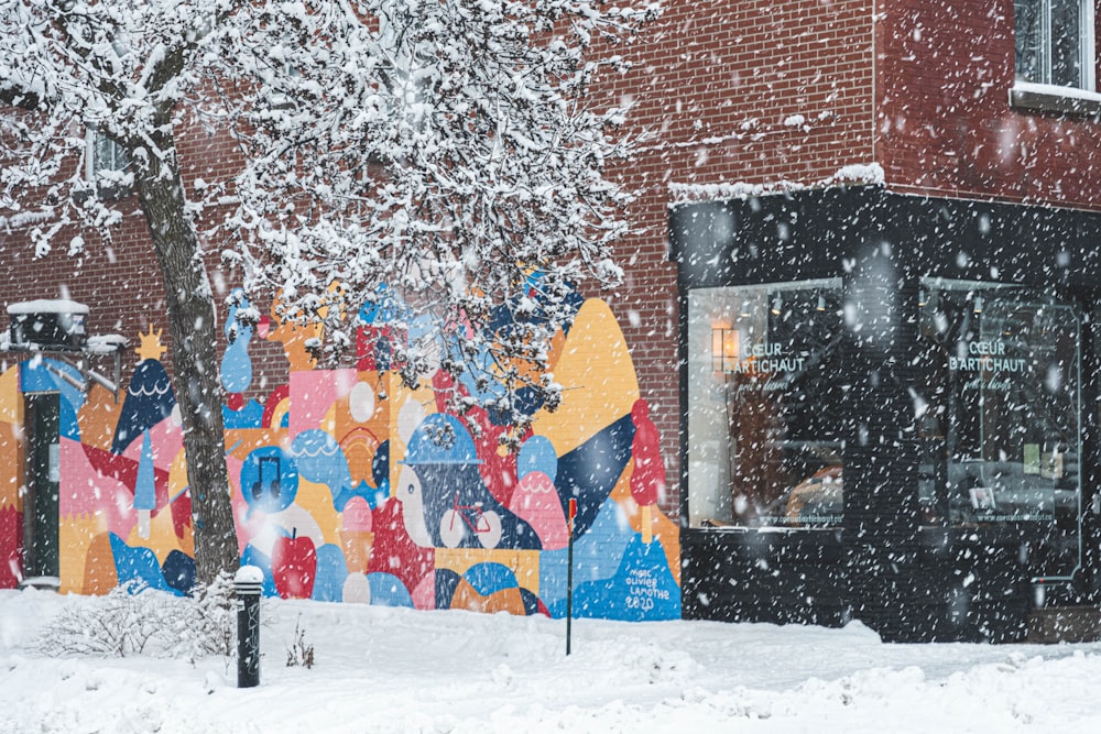 red blue and yellow umbrella on snow covered ground