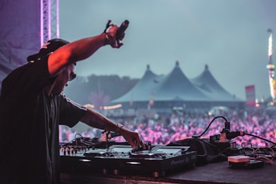 man in grey t-shirt playing dj mixer coachella zoom background