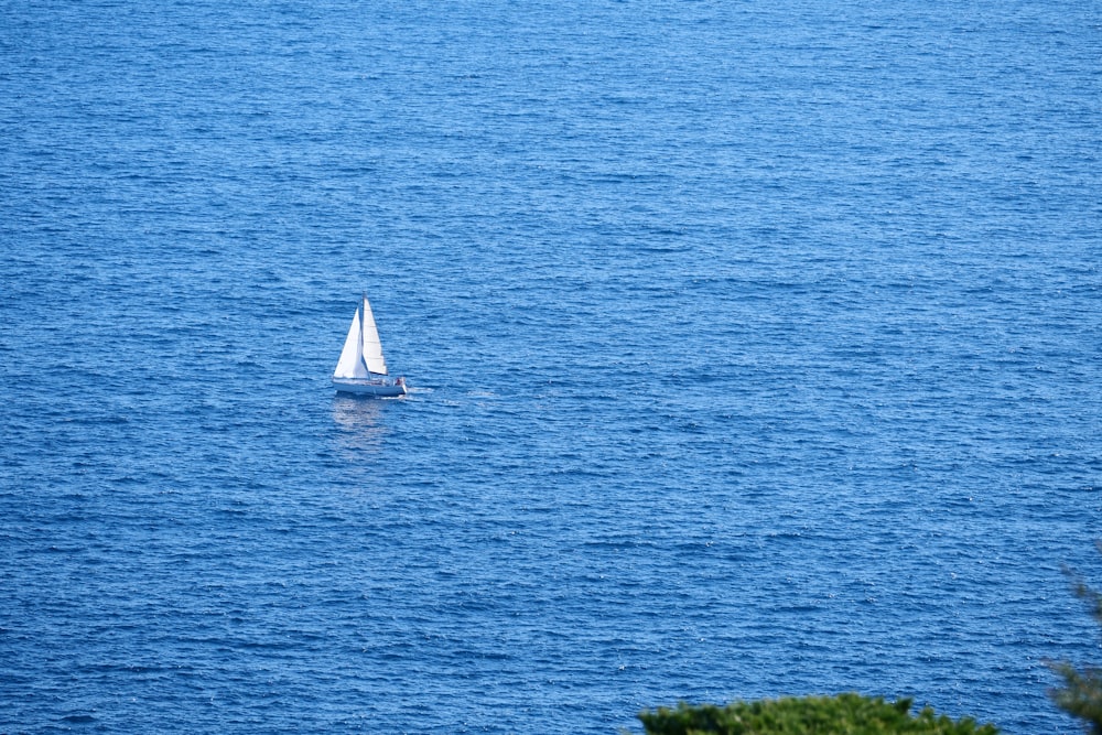 white sailboat on blue sea during daytime