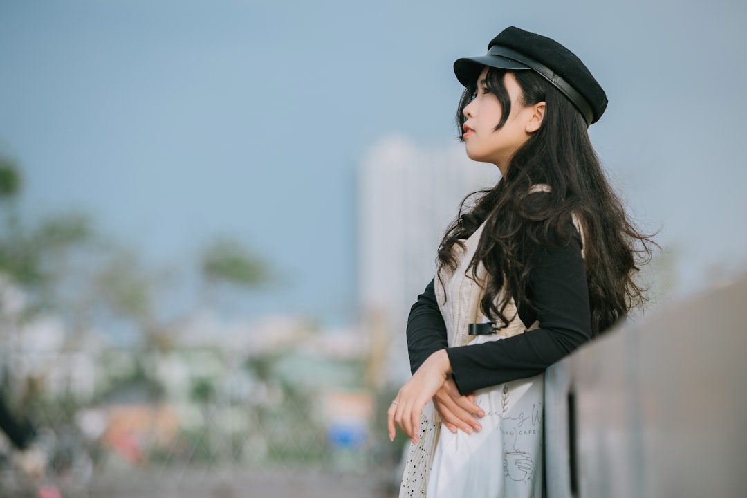 woman in black hat and brown leather jacket