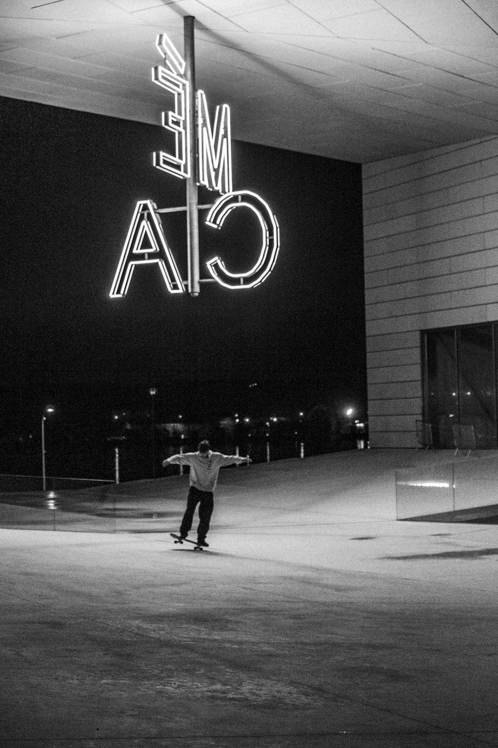 grayscale photo of man walking on street