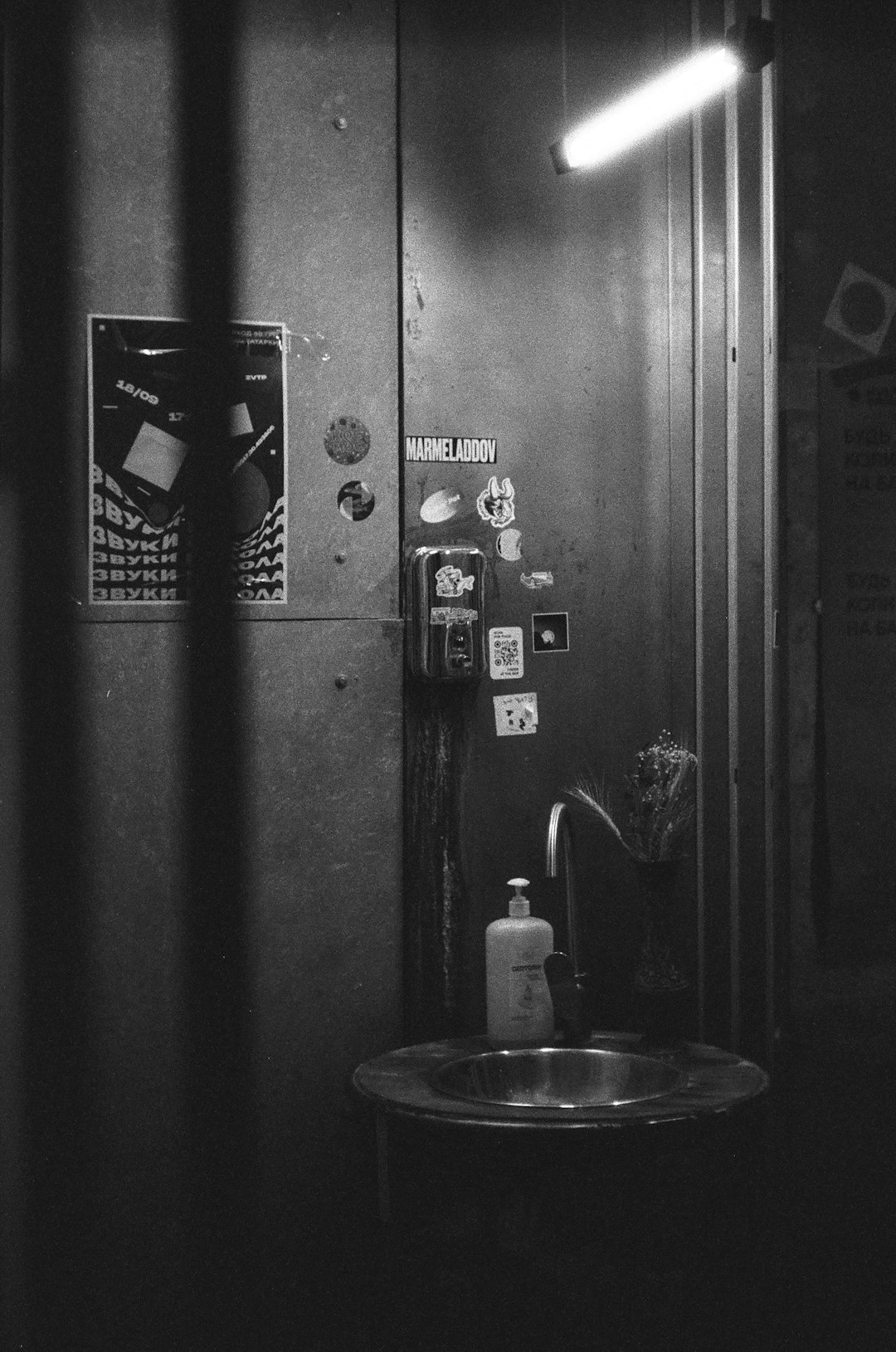 grayscale photo of round sink with faucet