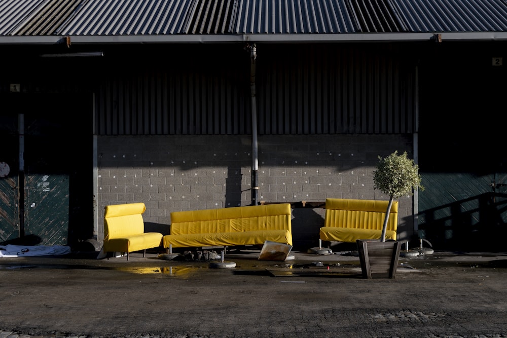 yellow and black bench near black wall