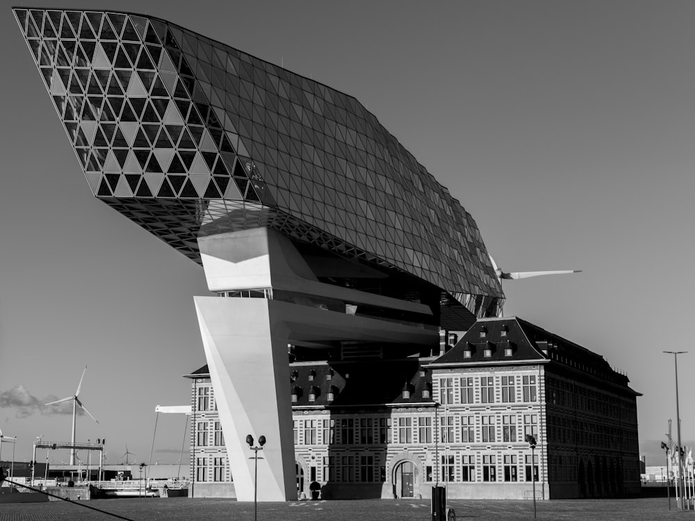 grayscale photo of building near body of water