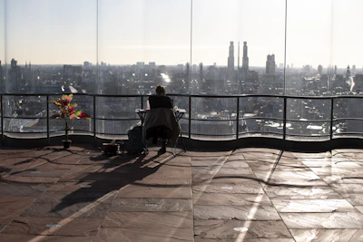 A recruiter reviewing resumes on a laptop with a Panama City skyline visible through the window.