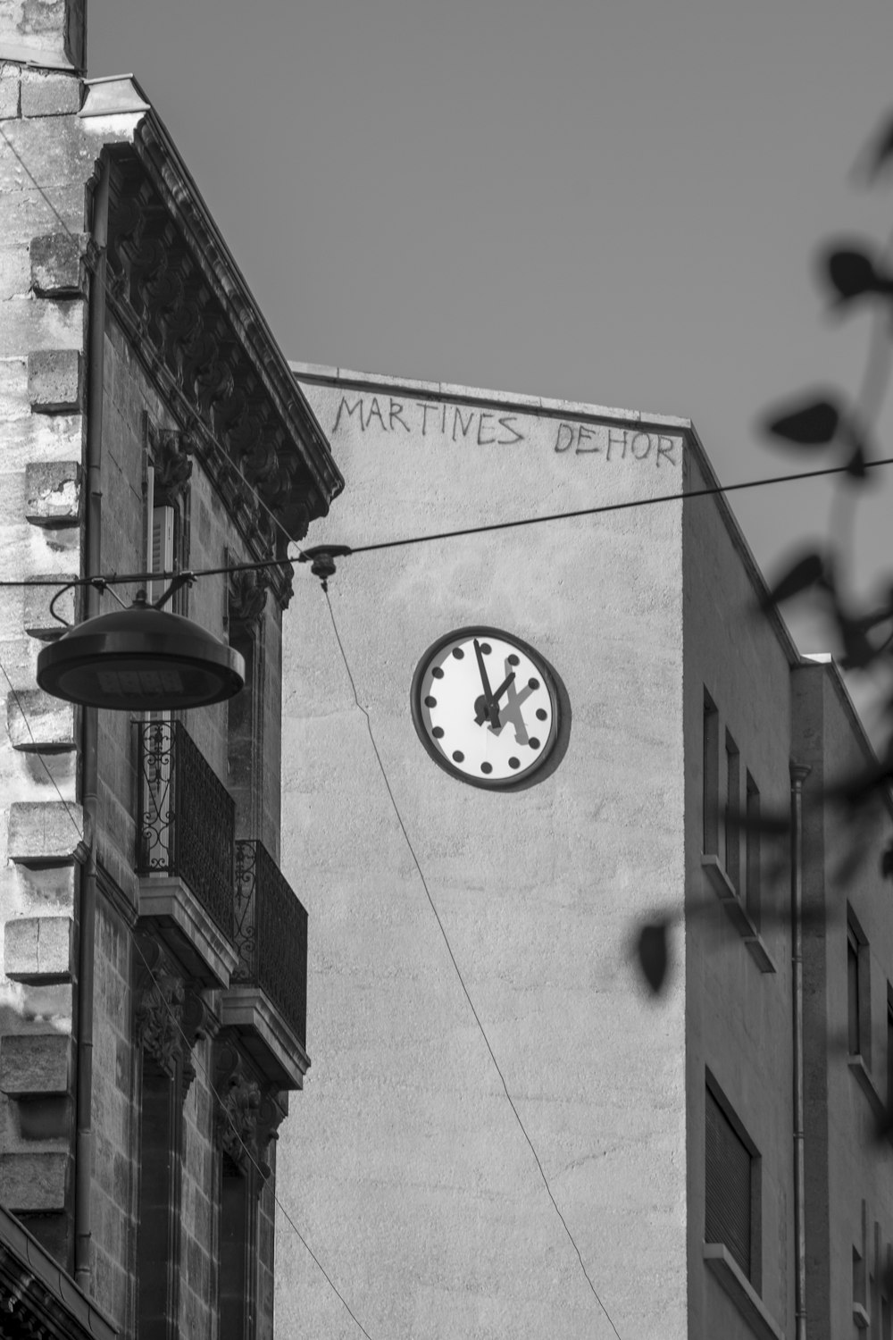 grayscale photo of round analog clock
