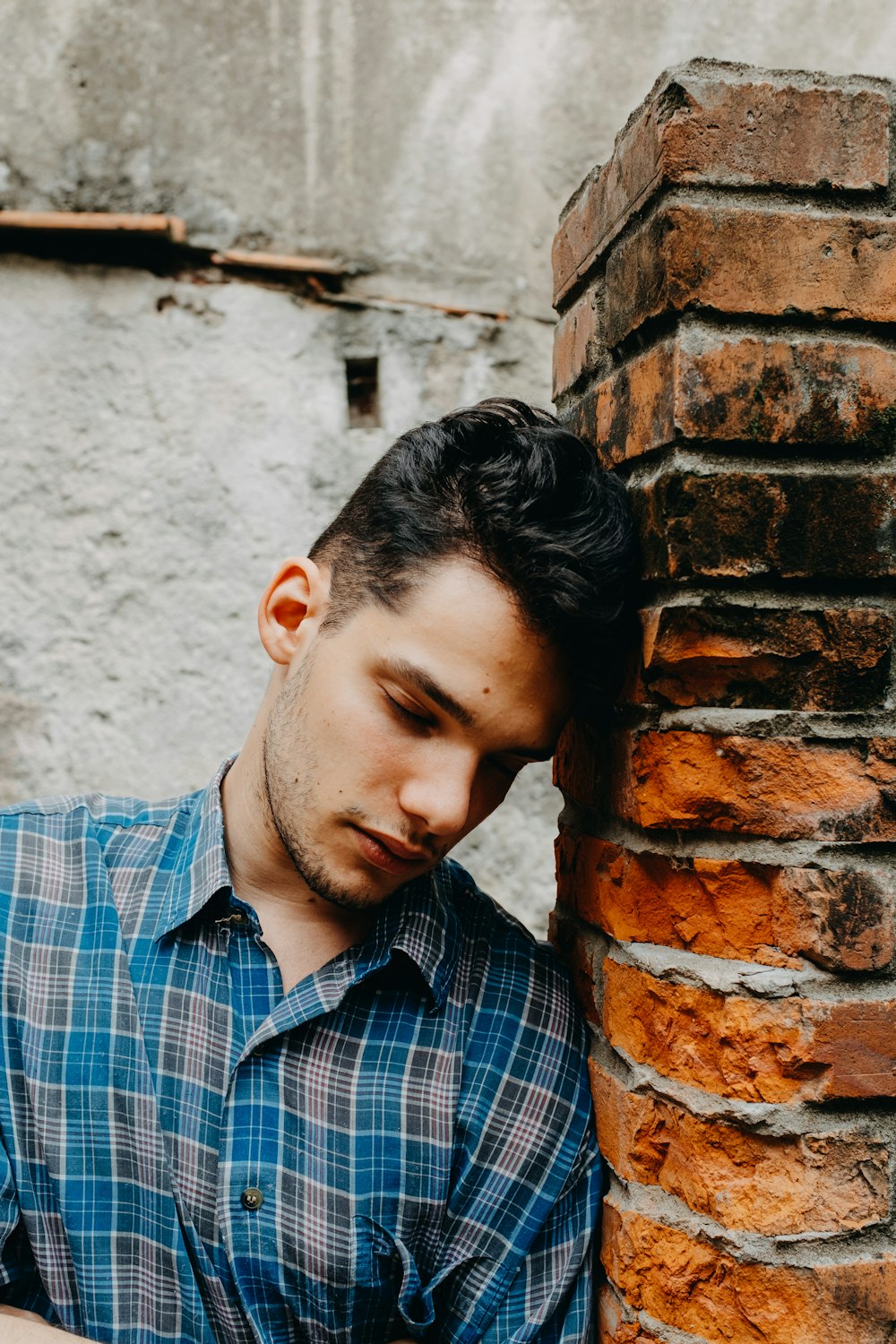 man in blue and white plaid button up shirt