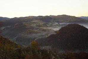 Panoramic view of rolling hills and wooded landscapes around Altenau in early morning light