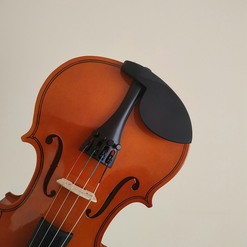brown violin on white surface