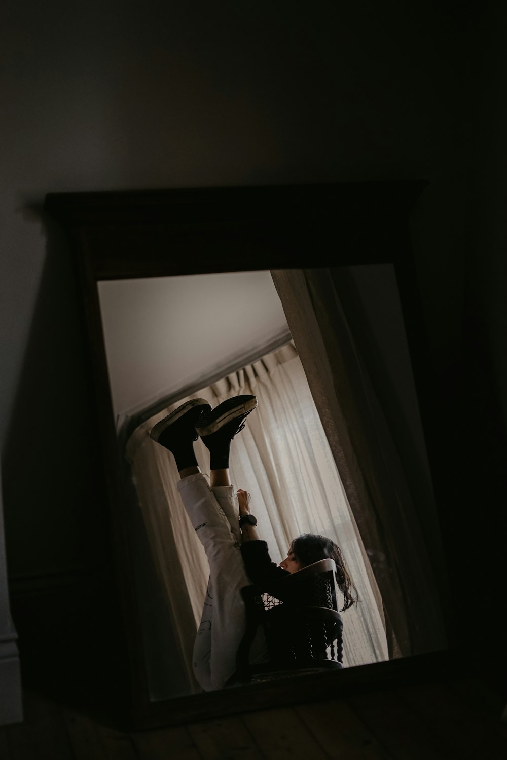 man in black shirt lying on bed