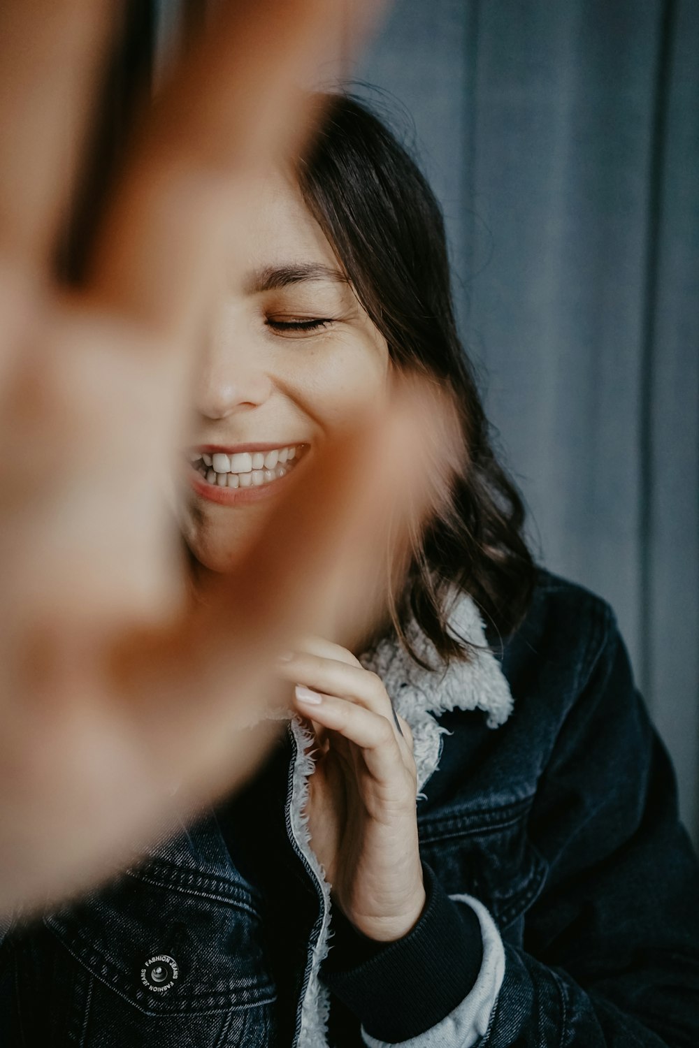 smiling woman in blue denim jacket