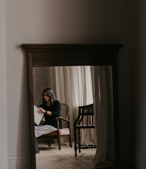 woman in white long sleeve shirt sitting on chair