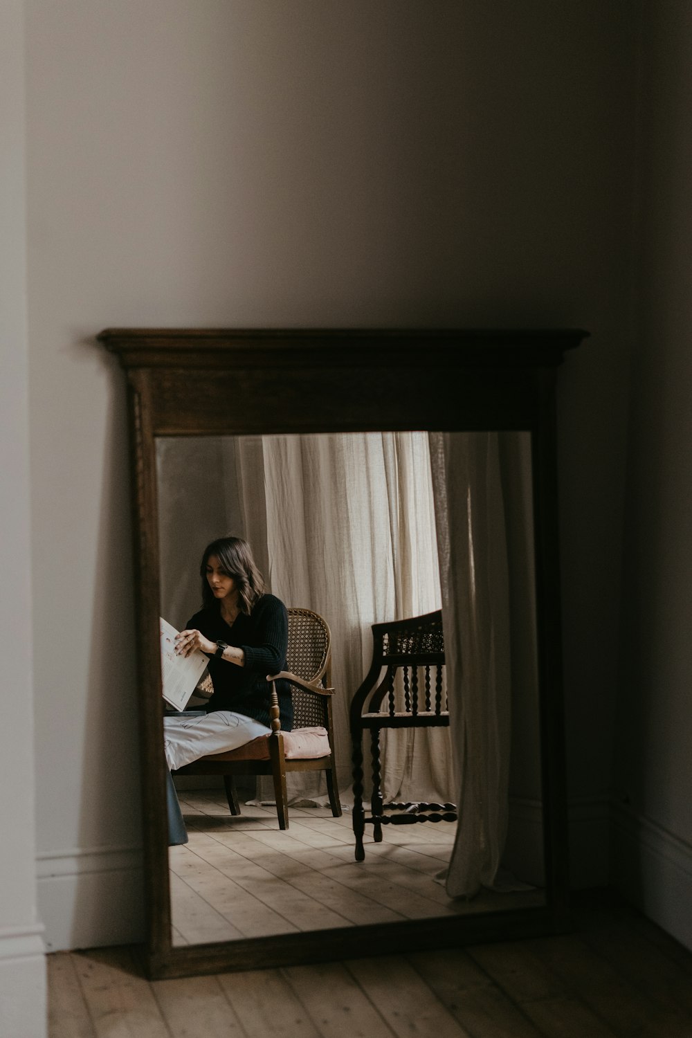 woman in white long sleeve shirt sitting on chair