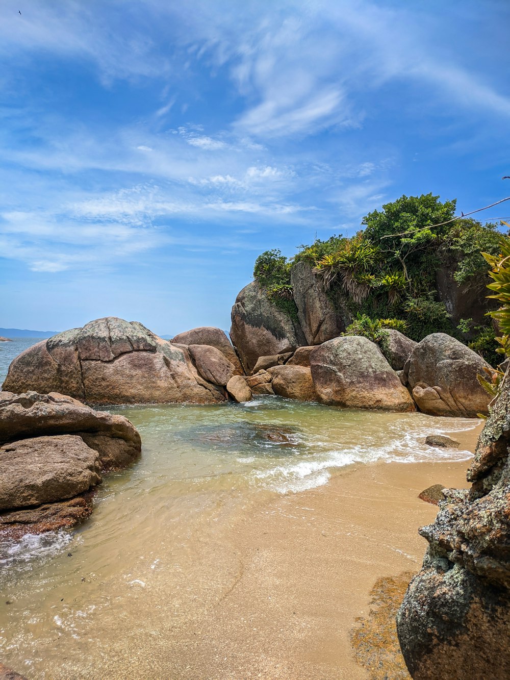 brown rock formation on body of water during daytime