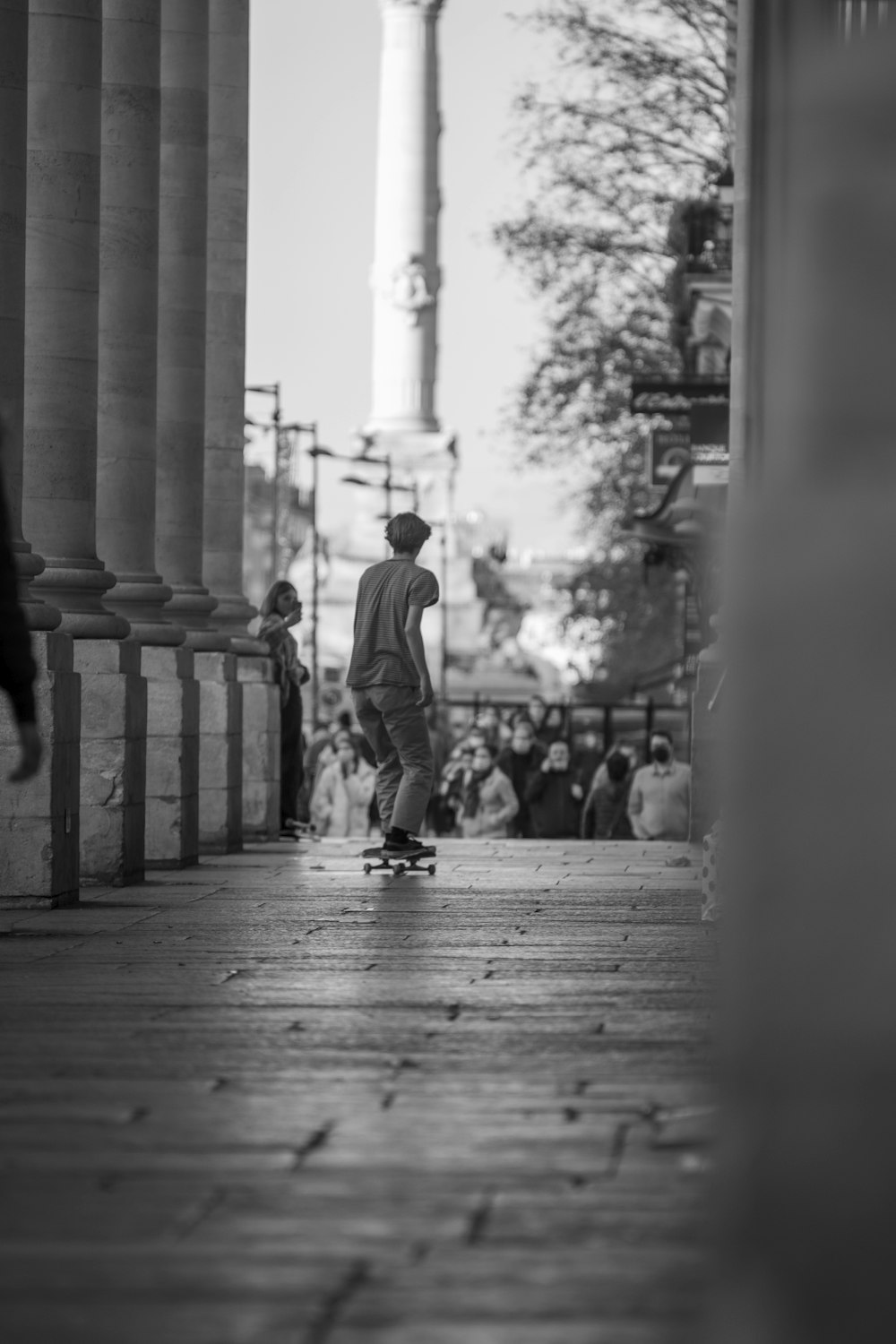 a man riding a skateboard down a sidewalk