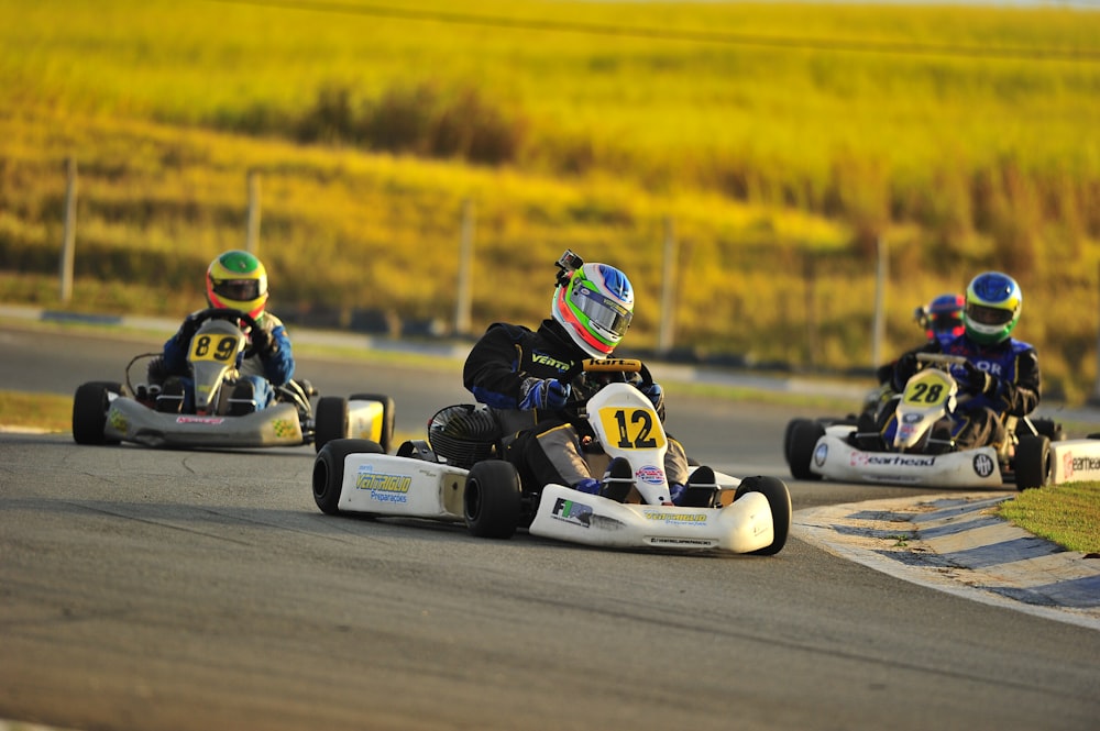 person riding on white and black go kart