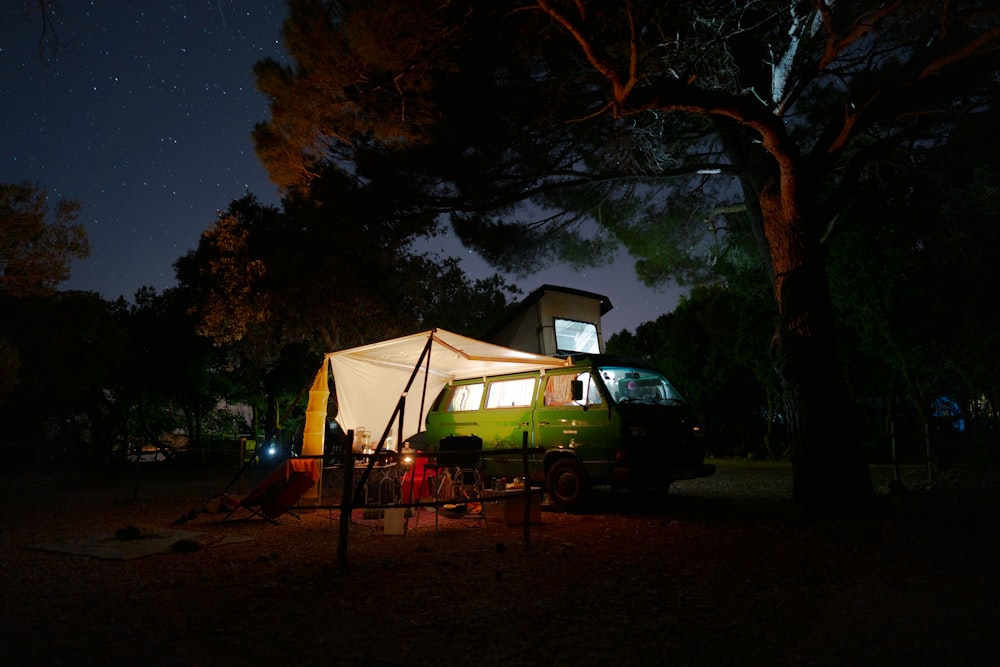 green car parked near white tent during night time