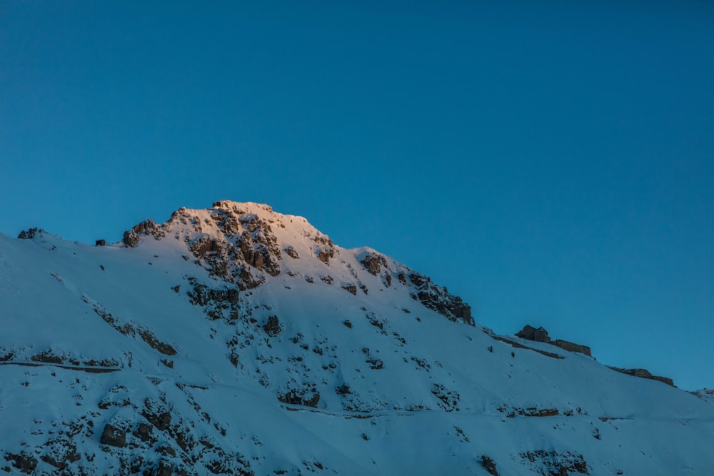 snow covered mountain under blue sky during daytime