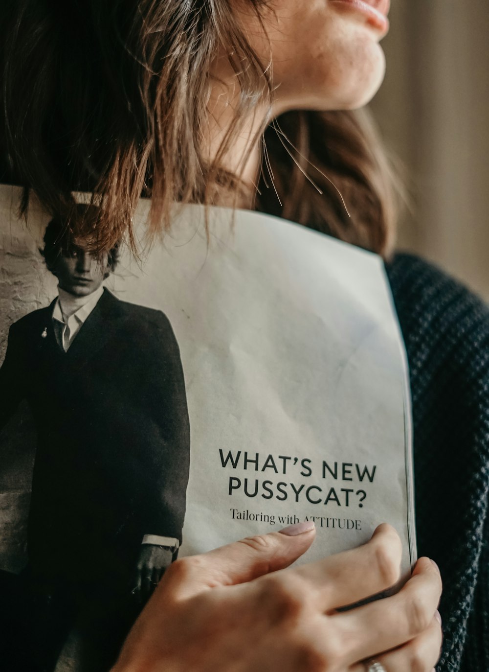 woman in black blazer holding white printer paper