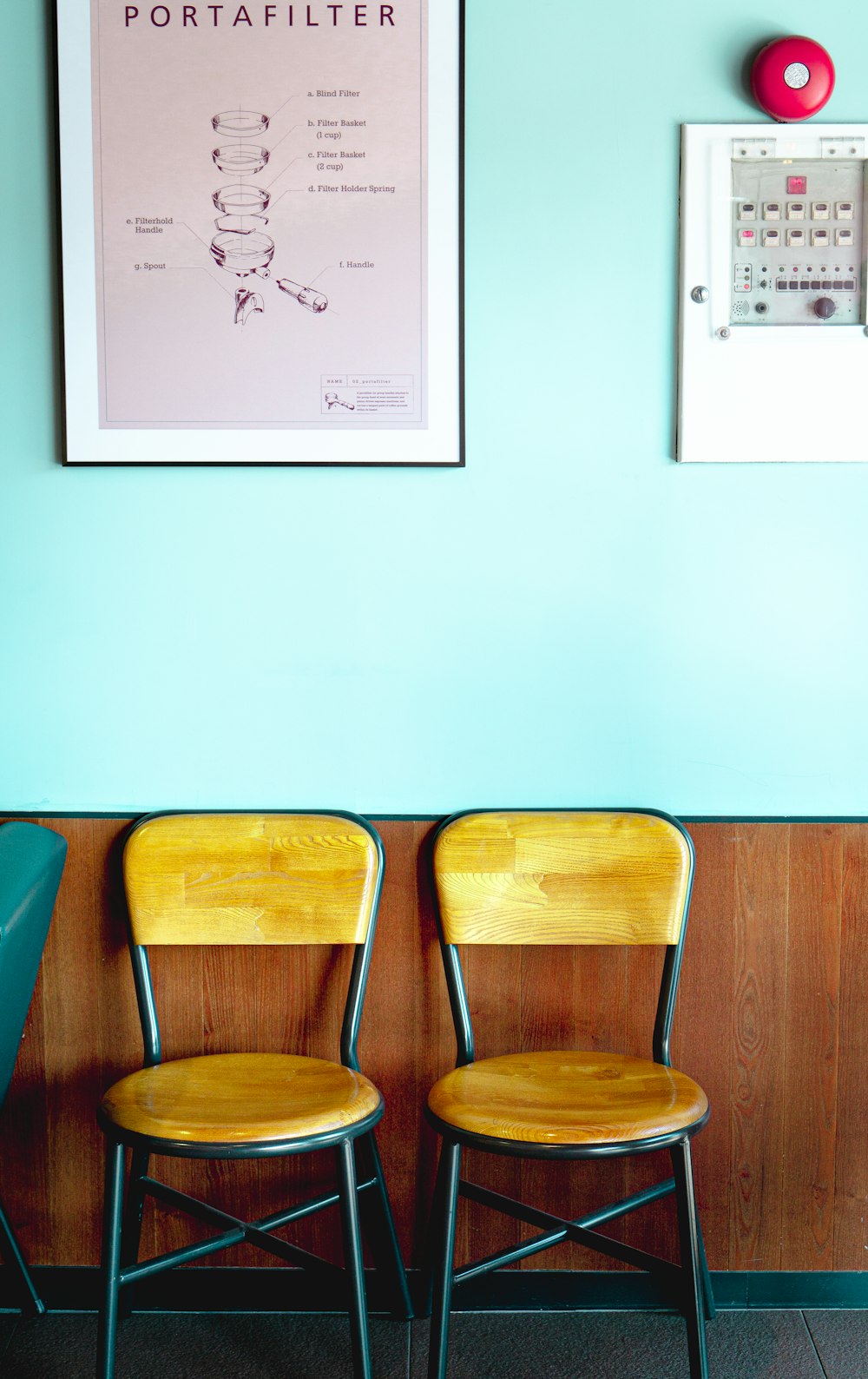 brown wooden chair beside white wall