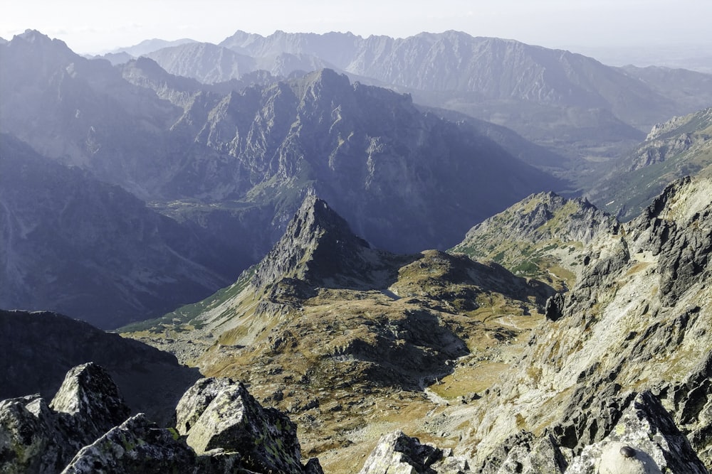 brown and green mountains under white sky during daytime