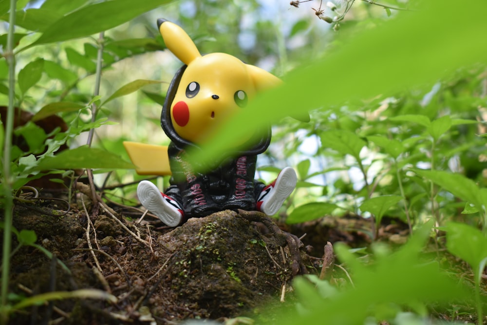 yellow and black bird plush toy on brown tree trunk