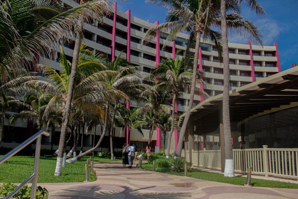 people walking on sidewalk near building during daytime