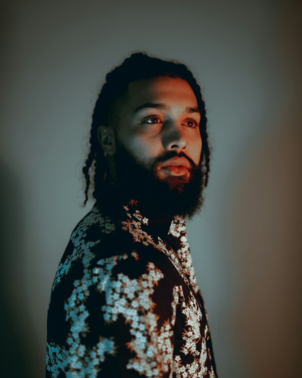 man in black and white floral shirt