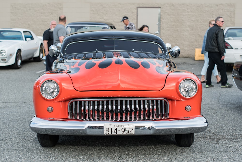 red vintage car on road during daytime