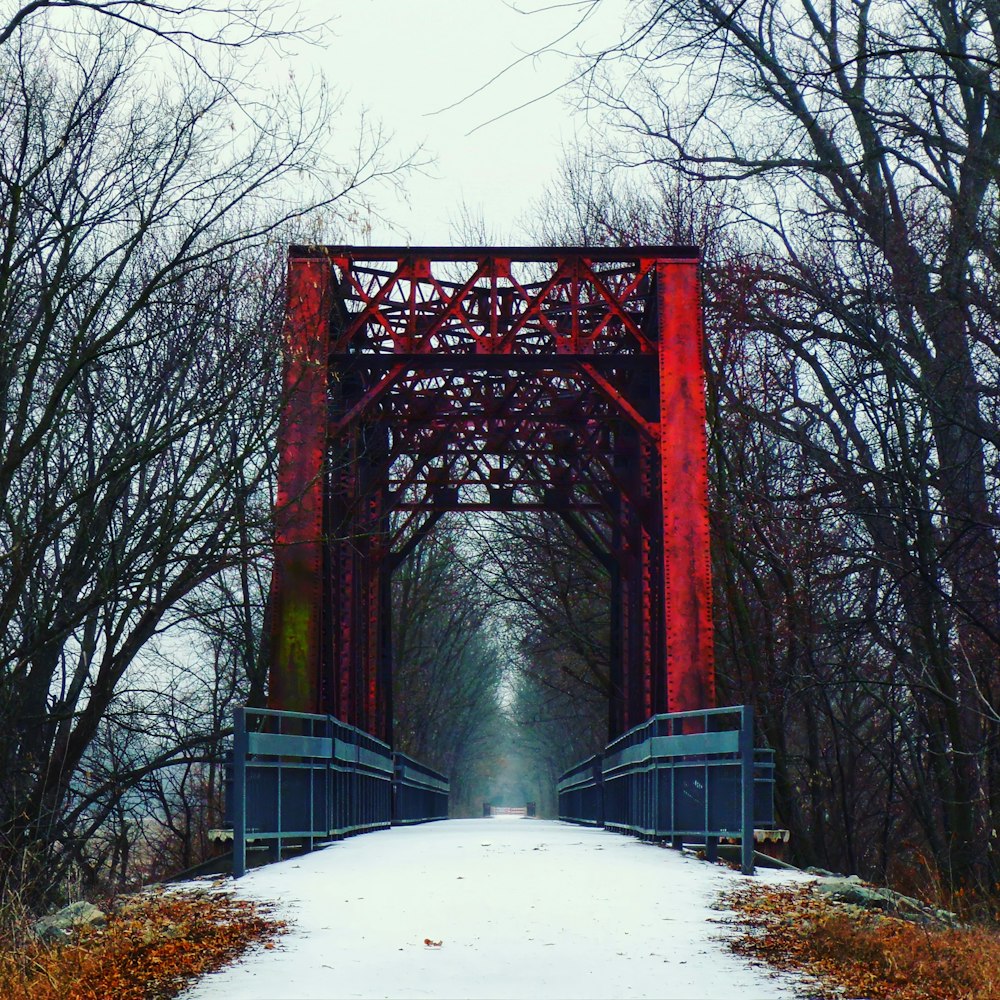 red bridge over snow covered ground