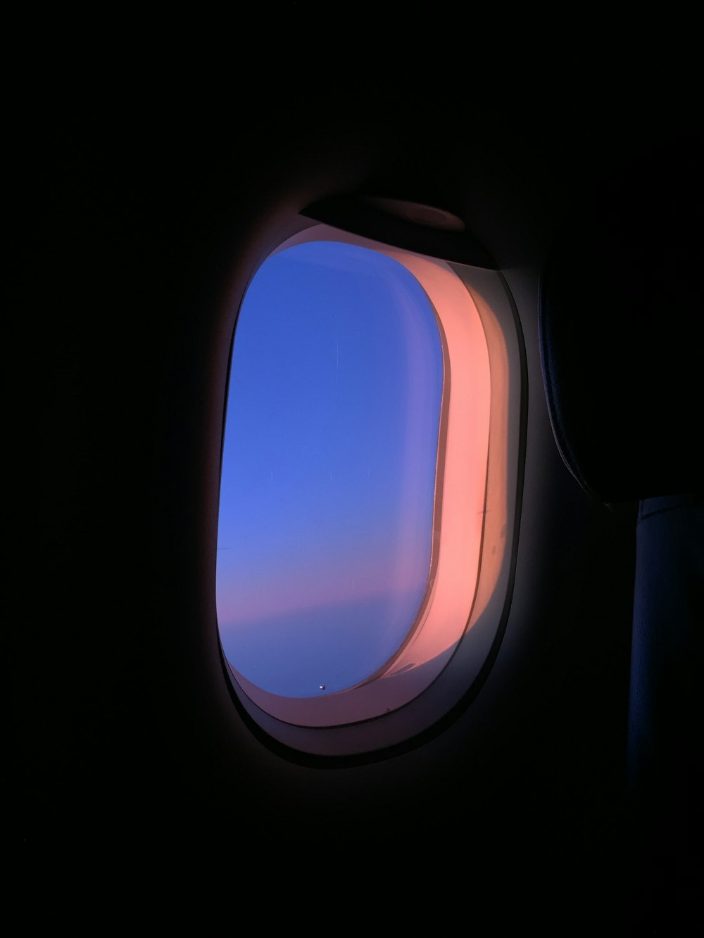 airplane window view of blue sky during daytime