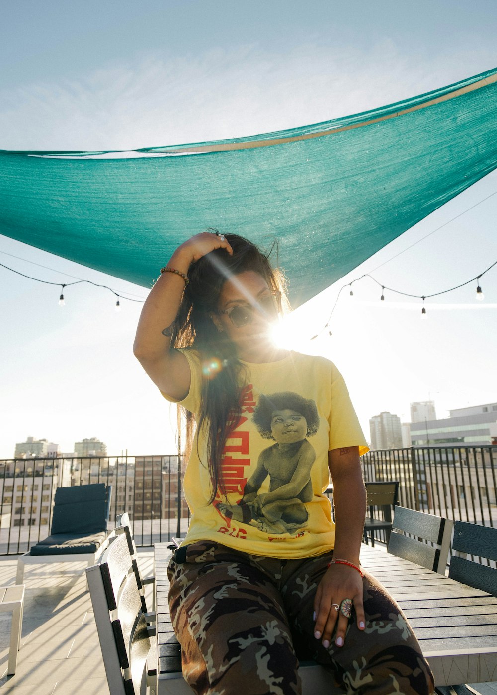 woman in yellow crew neck t-shirt sitting on black chair during daytime