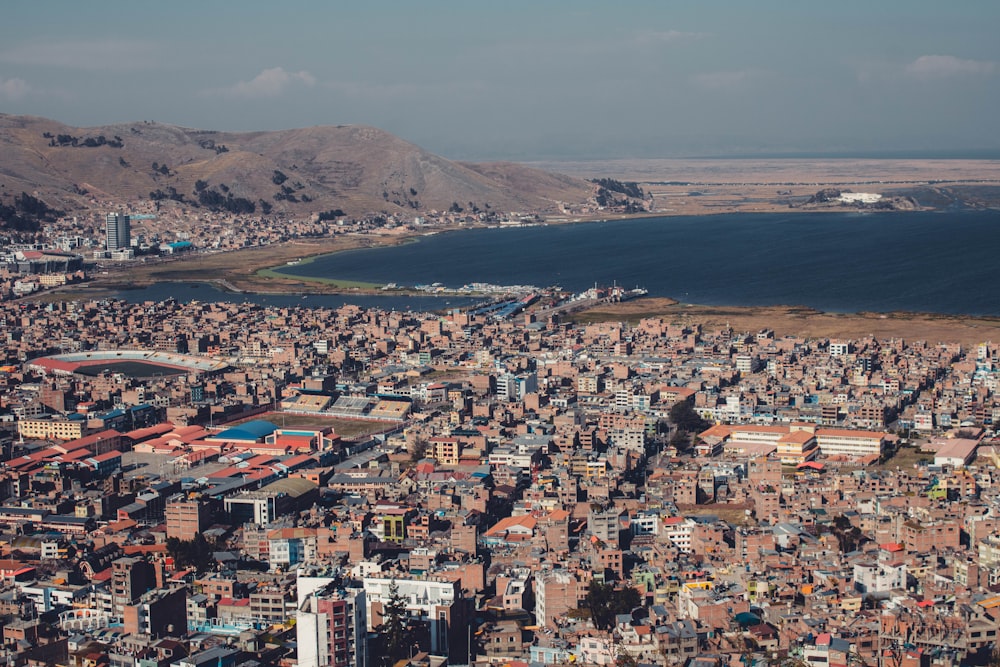 aerial view of city buildings near body of water during daytime