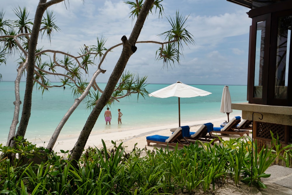 white beach umbrellas on beach during daytime